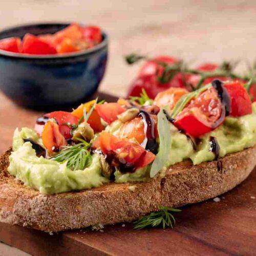 Geröstetes Brot mit Avocadobutter und Tomatensalat